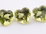 three green heart shaped gems on a white background