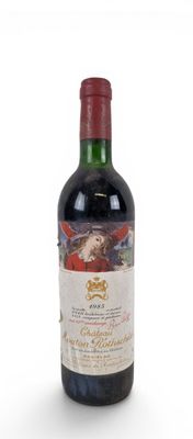 a close up of a bottle of wine on a white surface