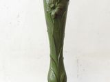 a green vase with a bird on top of it