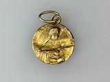an image of a gold medal with a woman holding a baby