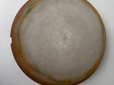 a white plate with a brown rim on a white table