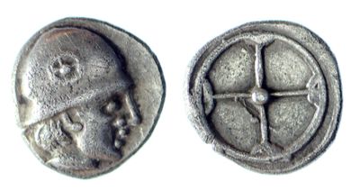 une image représentant une pièce d'argent sur laquelle figurent un visage et une croix