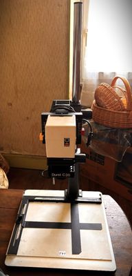 a camera sitting on a table next to a teddy bear
