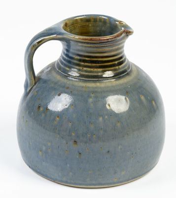 a blue vase with a handle on a white background
