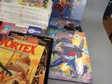 a lot of comic books on the table