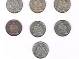 six different types of silver coins on a white surface