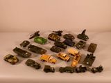 a lot of toy army vehicles on a white surface