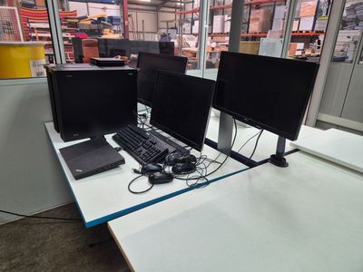two computer monitors and a keyboard on a desk