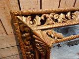 a mirror that is sitting on the floor in front of a wooden wall
