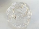 a clear glass bowl with a label on it on a table