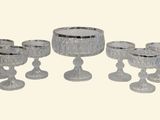 a group of glass goblets and cups sitting on a table