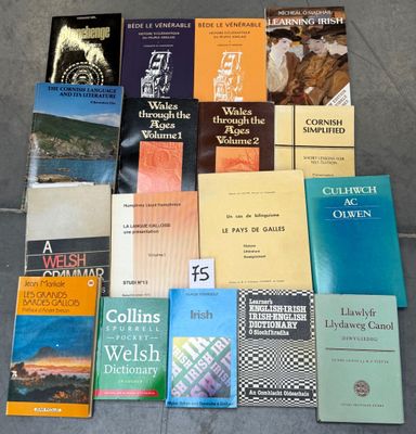 several books sitting on the ground next to each other on a table