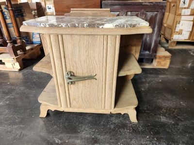 a small table with a marble top in a warehouse