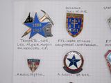 many badges on a piece of paper on the wall