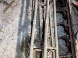 a close up of a bunch of rusty pipes on the ground