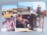 several old western movie posters are displayed on a table
