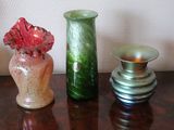 three vases sitting on a table next to each other