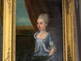 painting of a young girl in a blue dress in a gold frame