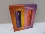 an image of a couple of bottles of perfume sitting on top of a table