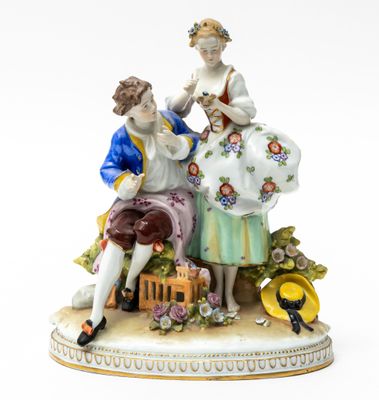 a figurine of a man and a woman sitting on a bench