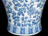 a blue and white vase with flowers on it