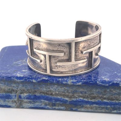 sterling silver cuff bracelet with geometric design on a blue stone