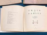 two books that are open on a blue table