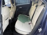 the back seats of a car with a luggage bag in the back