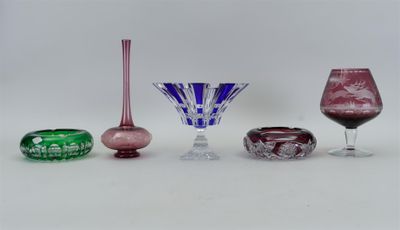 quatre vases en verre de couleurs différentes posés sur une surface blanche