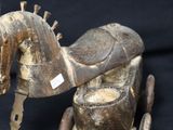a wooden toy horse that is sitting on a black surface
