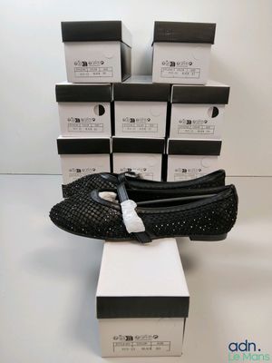 the black shoes are sitting on top of a box of boxes