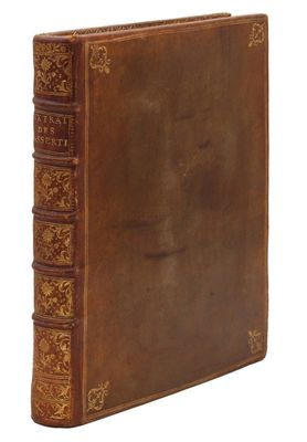 an old book with a brown cover sitting on top of a white surface