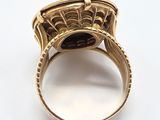 a close up of a gold ring with a black stone in it