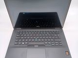 a laptop that is open on a white surface