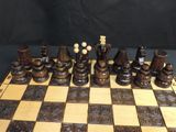 a chess board that has a lot of chess pieces on it