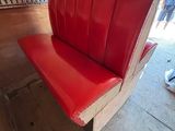 a red bench that is sitting in the middle of a room