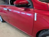 a red car parked in a garage with a sticker on the door