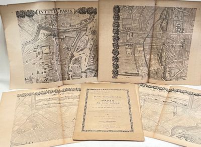 several old maps of paris on display on a table