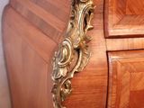 a wooden dresser with a gold handle on it