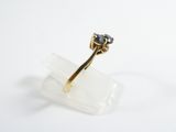 a close up of a gold ring with a sapphire stone on it