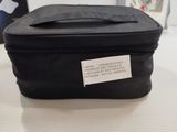 a black bag with a label on it sitting on a table