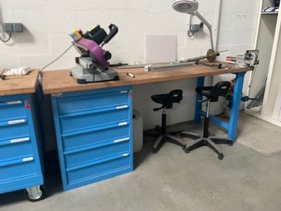 un établi bleu sur lequel est posé un microscope
