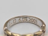 a close up of a gold ring with a date engraved on it