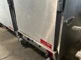an image of a stainless steel refrigerator in a warehouse