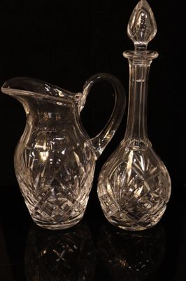 two clear glass vases sitting on top of a black table