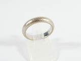 a close up of a silver ring on a white surface