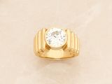 yellow gold ring with a single diamond in the center