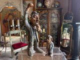 a statue of a man and a child in a living room