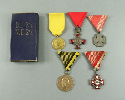several medals and a book are sitting on a table