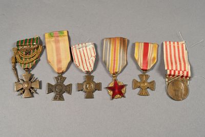 several medals and medals are arranged in a row on a gray surface